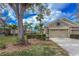 Lovely single-story home with a three-car garage, stone accents, and lush landscaping in a tranquil setting at 6930 Mystic Ln, Sarasota, FL 34243