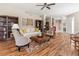 Cozy living room featuring hardwood floors, stylish furniture, and neutral paint tones at 6930 Mystic Ln, Sarasota, FL 34243