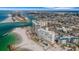 Scenic aerial view of coastline condos with sandy beaches, city, and river at 7000 Beach Plz # 905, St Pete Beach, FL 33706