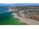 Stunning aerial view of shoreline condos with white beaches and the cityscape at 7000 Beach Plz # 905, St Pete Beach, FL 33706
