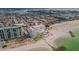 Aerial view of the coastline and high-rise condos with nearby beaches and a pool at 7000 Beach Plz # 905, St Pete Beach, FL 33706
