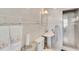 Updated bathroom with decorative tile accents, pedestal sink, and glass-enclosed shower at 7000 Beach Plz # 905, St Pete Beach, FL 33706