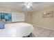 Bedroom featuring neutral walls, tile flooring, and a ceiling fan at 7000 Beach Plz # 905, St Pete Beach, FL 33706