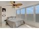 Cozy bedroom with beach-themed decor, a ceiling fan, and multiple windows offering plenty of natural light at 7000 Beach Plz # 905, St Pete Beach, FL 33706