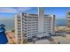Exterior view of high-rise condominium building near beach showing architectural design at 7000 Beach Plz # 905, St Pete Beach, FL 33706