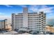 Exterior view of high-rise condominium building near the beach with stairway access on each side at 7000 Beach Plz # 905, St Pete Beach, FL 33706