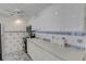 Kitchen with white cabinetry, light countertops, and tile backsplash at 7000 Beach Plz # 905, St Pete Beach, FL 33706