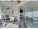 Relaxing sunroom featuring wicker furniture, a ceiling fan, and sliding glass doors offering a view of the outdoors at 7000 Beach Plz # 905, St Pete Beach, FL 33706