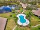 Stunning aerial shot featuring a community pool, gazebo, and beautiful lakeside homes at 7123 Heron Dr, Sarasota, FL 34243