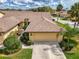Aerial view of the home featuring a well maintained roof, driveway, and tropical landscaping at 7123 Heron Dr, Sarasota, FL 34243