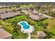 Beautiful aerial shot showcasing a community pool, surrounded by homes and lush landscaping at 7123 Heron Dr, Sarasota, FL 34243