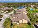 Fantastic aerial view showing the community, lush landscaping, pool, and lakeside homes at 7123 Heron Dr, Sarasota, FL 34243