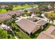 Stunning aerial perspective of the property featuring a golf course, pond, and palm trees at 7123 Heron Dr, Sarasota, FL 34243