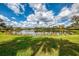 Picturesque view of the lake and grass from the backyard at 7123 Heron Dr, Sarasota, FL 34243