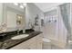Serene bathroom with granite countertop, decorative starfish accents, and tub with shower at 7123 Heron Dr, Sarasota, FL 34243