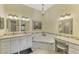 Elegant bathroom with dual sinks, granite countertops, decorative mirrors, and a soaking tub at 7123 Heron Dr, Sarasota, FL 34243