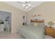 Comfortable bedroom with ceiling fan, natural light, and decorative shelf at 7123 Heron Dr, Sarasota, FL 34243