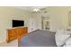 Bedroom featuring a dresser with TV, a bed, and doorway view to the bath at 7123 Heron Dr, Sarasota, FL 34243