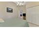 Cozy bedroom featuring closet space, neutral tones and ceiling fan at 7123 Heron Dr, Sarasota, FL 34243