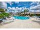 Large community pool with ample seating and umbrellas for a resort-style experience at 7123 Heron Dr, Sarasota, FL 34243