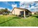 Exterior view of home with lush landscaping and screened lanai in the back at 7123 Heron Dr, Sarasota, FL 34243