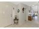 Bright foyer with neutral tile, white front door, and decorative accents at 7123 Heron Dr, Sarasota, FL 34243