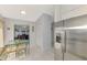 Bright kitchen with stainless steel refrigerator, tile flooring, and eat in dining area at 7123 Heron Dr, Sarasota, FL 34243