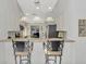 Eat-in kitchen offers stainless steel appliances, breakfast bar, and modern pendant lighting at 7123 Heron Dr, Sarasota, FL 34243