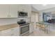 Updated kitchen featuring stainless appliances, granite countertops, and white cabinets at 7123 Heron Dr, Sarasota, FL 34243