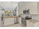 Open kitchen with stainless steel appliances, modern cabinetry, and granite countertops at 7123 Heron Dr, Sarasota, FL 34243