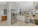 Kitchen featuring stainless steel appliances, granite counters, tile floors, and white cabinetry at 7123 Heron Dr, Sarasota, FL 34243