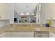 Kitchen featuring granite countertops, modern sink, and view into the living room at 7123 Heron Dr, Sarasota, FL 34243