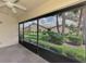 Relaxing screened lanai with a beautiful view of the lush landscaped yard and neighborhood at 7123 Heron Dr, Sarasota, FL 34243