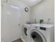 This laundry room includes a washer, dryer, and a door to the exterior of the home at 7123 Heron Dr, Sarasota, FL 34243