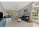 Comfortable living room featuring tile floors, ceiling fan, and sliding glass doors to lanai at 7123 Heron Dr, Sarasota, FL 34243