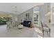 Bright living room featuring tile floors, high ceilings, fan, and a large window at 7123 Heron Dr, Sarasota, FL 34243