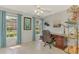 Well-lit home office with a dark wood desk, curtains and windows with a neighborhood view at 7123 Heron Dr, Sarasota, FL 34243