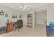 Comfortable home office featuring wood desk, shelving, and bright interior at 7123 Heron Dr, Sarasota, FL 34243