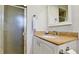 Bathroom featuring granite counters, white cabinetry, a frosted glass shower and an updated mirror at 7208 13Th W Ave, Bradenton, FL 34209