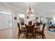 Dining area with a glass-top table, seating for six, and views into the kitchen and living spaces at 780 Montrose Dr # 104, Venice, FL 34293