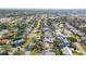 Wide aerial perspective of a community showcasing houses with green lawns and a variety of trees at 7807 24Th W Ave, Bradenton, FL 34209