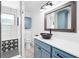 Stylish bathroom with modern vanity, vessel sink, sleek faucet, and a tiled shower at 7807 24Th W Ave, Bradenton, FL 34209