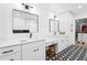 Stylish bathroom featuring double sinks, modern fixtures, and unique black-and-white patterned flooring at 7807 24Th W Ave, Bradenton, FL 34209