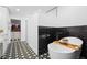 Modern bathroom with a soaking tub, stylish tile floor, and walk-in closet at 7807 24Th W Ave, Bradenton, FL 34209