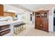 Another view of the bright kitchen, with white countertops, warm wood cabinets, and breakfast bar seating at 7807 24Th W Ave, Bradenton, FL 34209