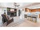 Inviting living room featuring a cozy fireplace, comfortable seating, and an open layout with a breakfast bar at 7807 24Th W Ave, Bradenton, FL 34209