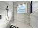 Modern shower features gray and white tiling, black showerhead, and built in bench at 7807 24Th W Ave, Bradenton, FL 34209