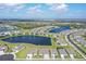 Aerial view of the neighborhood showcasing the lake, landscaping, and community layout at 9028 Sunray Cv, Parrish, FL 34219