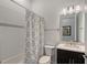 Bathroom featuring a tub/shower with decorative tiling and a dark vanity with white countertop at 9028 Sunray Cv, Parrish, FL 34219