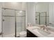 Modern bathroom featuring a glass-enclosed shower, white subway tile, and a marble countertop vanity at 9028 Sunray Cv, Parrish, FL 34219